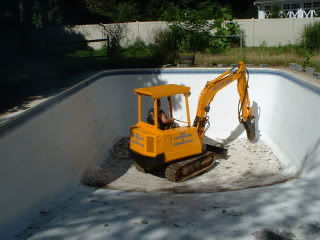 bobcat in a pool for our Oakland, CA Pool Demolition experts